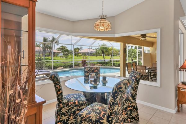 Kitchen knook overlooking the sparkling pool. Table seats 4