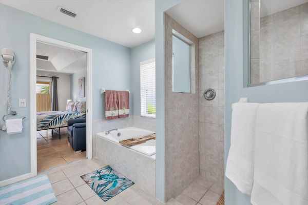 Primary ensuite with walk-in shower, soaking tub, and double vanities