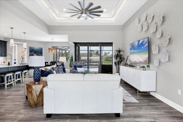 Beautiful, bright, open living space overlooking the sparkling pool and canal beyond