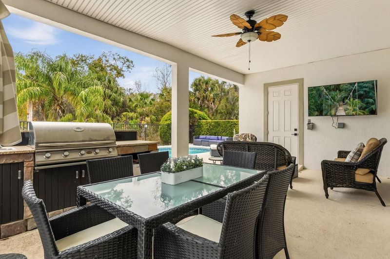 Relax and enjoy time with the family by the summer kitchen and pool