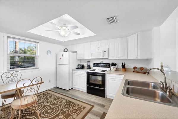 Fully-equipped kitchen overlooking dining and living room areas