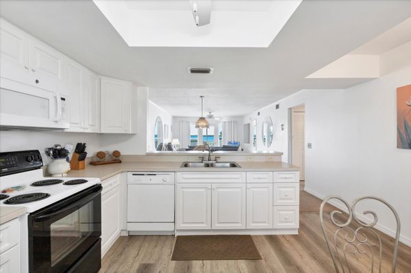 Fully-equipped kitchen overlooking dining and living room areas