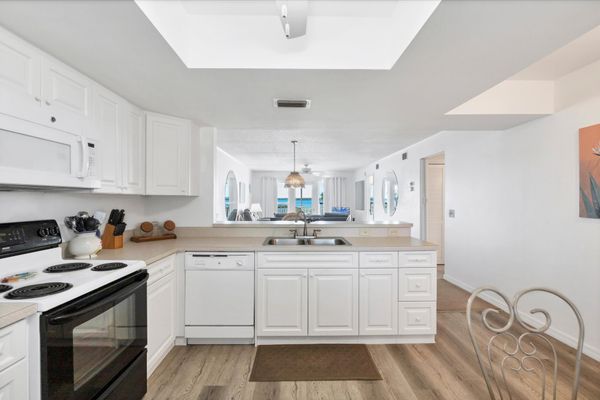 Fully-equipped kitchen overlooking dining and living room areas