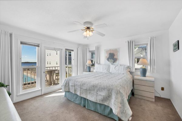 Primary bedroom with king bed, attached bathroom, balcony access and amazing water view