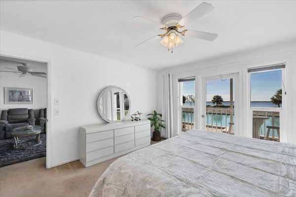 Primary bedroom with king bed, attached bathroom, balcony access and amazing water view