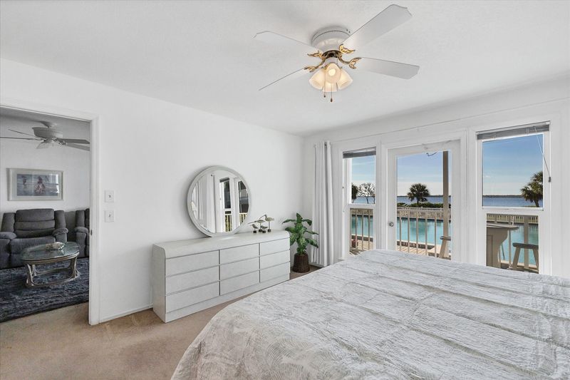 Primary bedroom with king bed, attached bathroom, balcony access and amazing water view