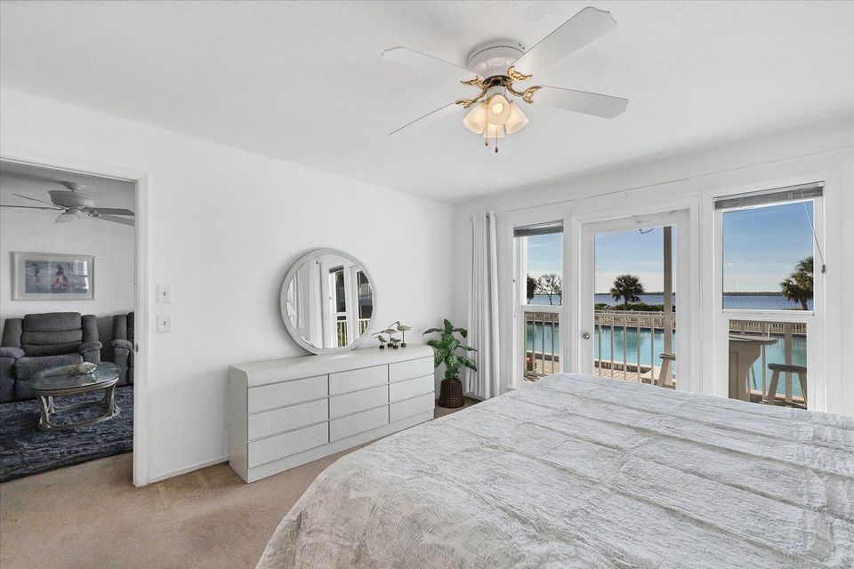 Primary bedroom with king bed, attached bathroom, balcony access and amazing water view
