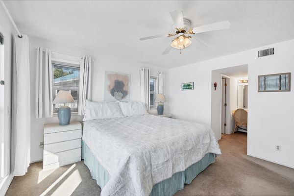 Primary bedroom with king bed, attached bathroom, balcony access and amazing water view