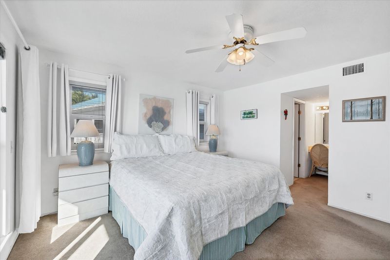 Primary bedroom with king bed, attached bathroom, balcony access and amazing water view