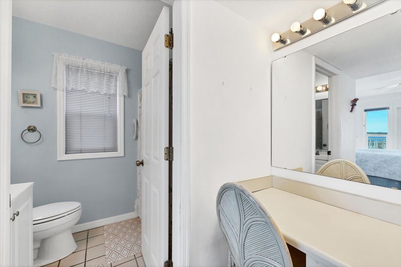 Primary bedroom attached bathroom with vanity area and shower/tub combo