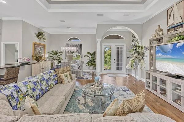 Beautiful open living space. Living room features lots of comfy seating and a 75" Smart TV