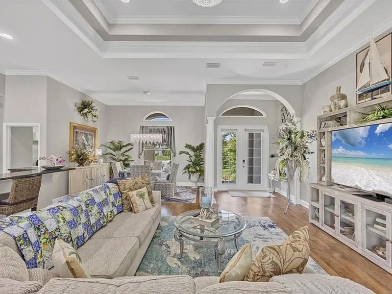 Beautiful open living space. Living room features lots of comfy seating and a 75" Smart TV