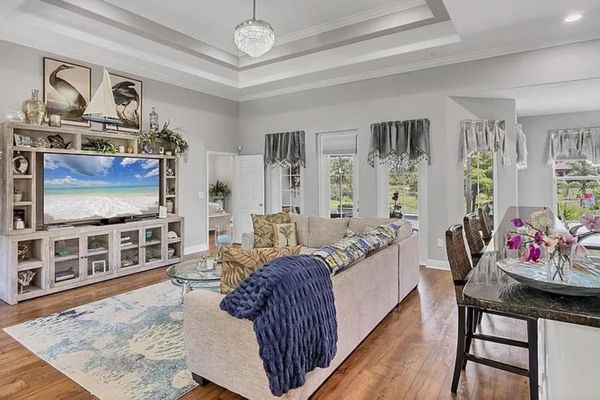 Beautiful open living space. Living room features lots of comfy seating and a 75" Smart TV