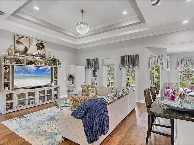 Beautiful open living space. Living room features lots of comfy seating and a 75" Smart TV