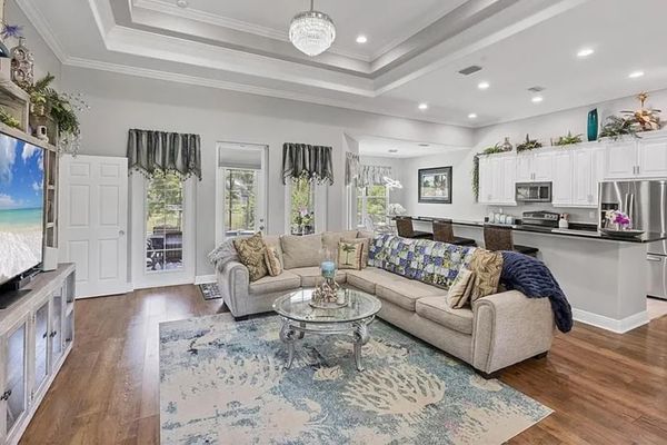 Beautiful open living space. Living room features lots of comfy seating and a 75" Smart TV