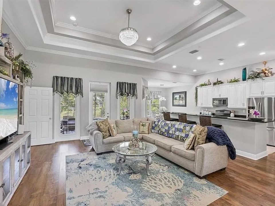 Beautiful open living space. Living room features lots of comfy seating and a 75" Smart TV