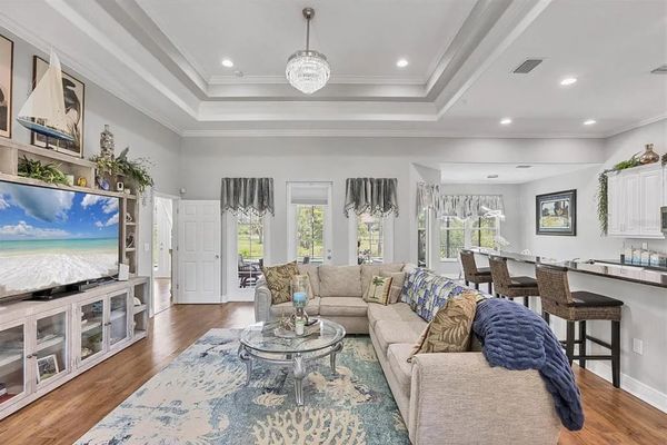 Beautiful open living space. Living room features lots of comfy seating and a 75" Smart TV