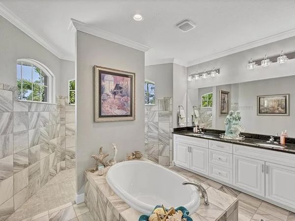 Primary en suite with large walk-in shower, soaking tub and double vanities