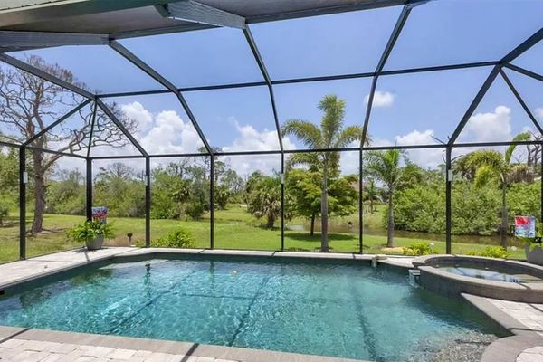 Sparkling pool & spa overlooking canal. Pool size: 22' x 14' x 6'. Spa seats 6