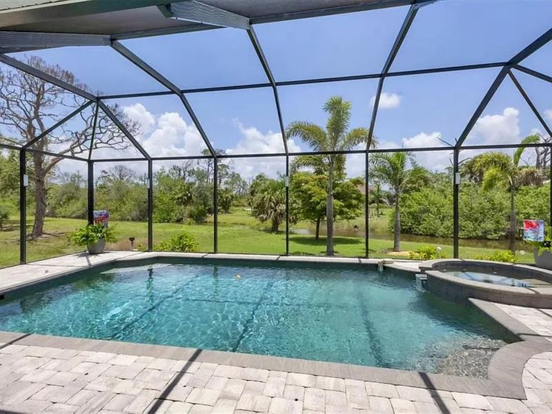 Sparkling pool & spa overlooking canal. Pool size: 22' x 14' x 6'. Spa seats 6