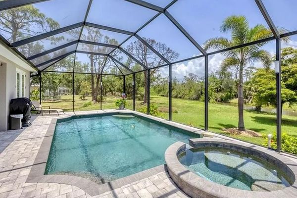 Sparkling pool & spa overlooking canal. Pool size: 22' x 14' x 6'. Spa seats 6