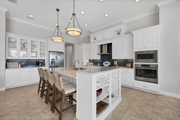 Gorgeous, fully-equipped kitchen over looking the living room and dining areas. Kitchen features lots of countertop & storage space, and stainless-steel appliances. Kitchen island seats 4