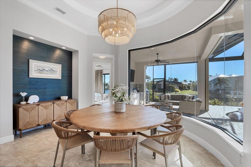 Dining area overlooking pool and canal. Dining table seats 8