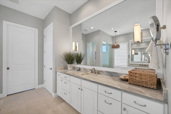 Primary attached bathroom with walk-in shower, soaking tub, and double vanities