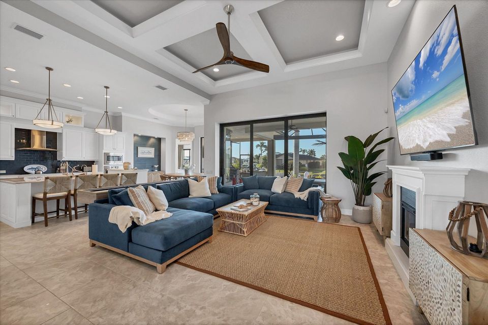 Beautiful, bright, open living space. Living room features ample seating, shuffleboard table, electric fireplace, lanai access, and huge 84-inch Smart TV