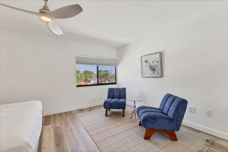 King bedroom with attached bathroom and view of bay