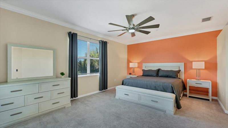 Primary bedroom with king bed and attached bathroom