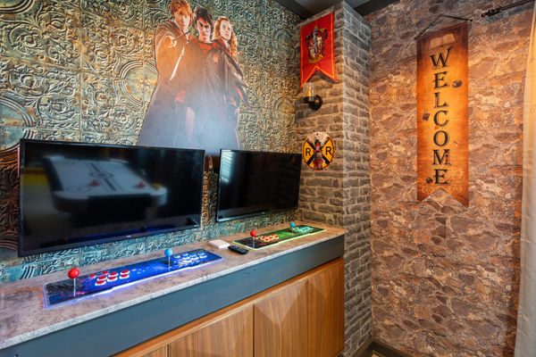 Two 32" Roku TVs with Game Consoles