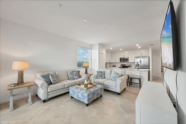 Bright, open living space. Living room overlooks the nature preserve and features ample seating and 65-inch Smart TV