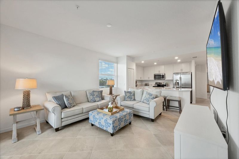 Bright, open living space. Living room overlooks the nature preserve and features ample seating and 65-inch Smart TV