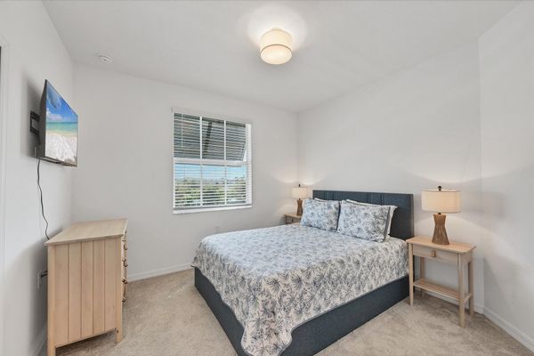 Guest bedroom 2 with one queen bed and 43-inch Smart TV