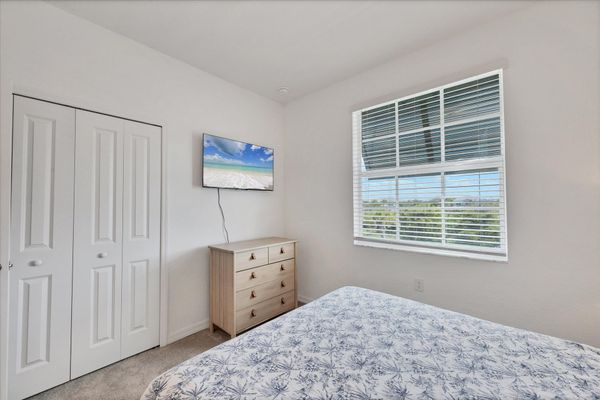 Guest bedroom 2 with one queen bed and 43-inch Smart TV