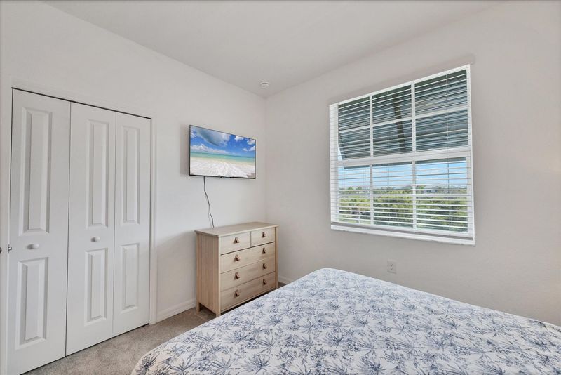 Guest bedroom 2 with one queen bed and 43-inch Smart TV