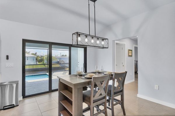 Dining area overlooing sparkling pool