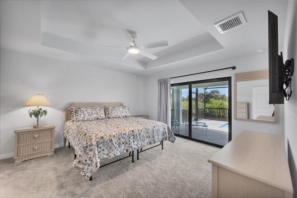 Primary bedroom with king bed, lanai access, en suite, and 55-inch Smart TV