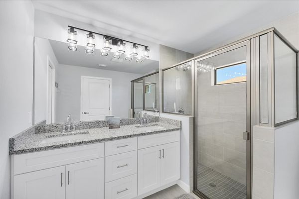 Primary en suite with walk-in shower and double vanities