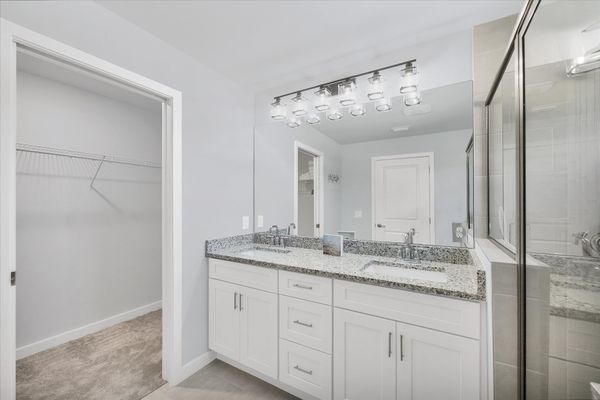 Primary en suite with walk-in shower and double vanities