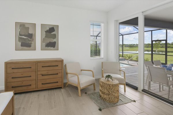 Primary bedroom with king bed, attached bathroom, lanai access, and 65-inch Smart TV