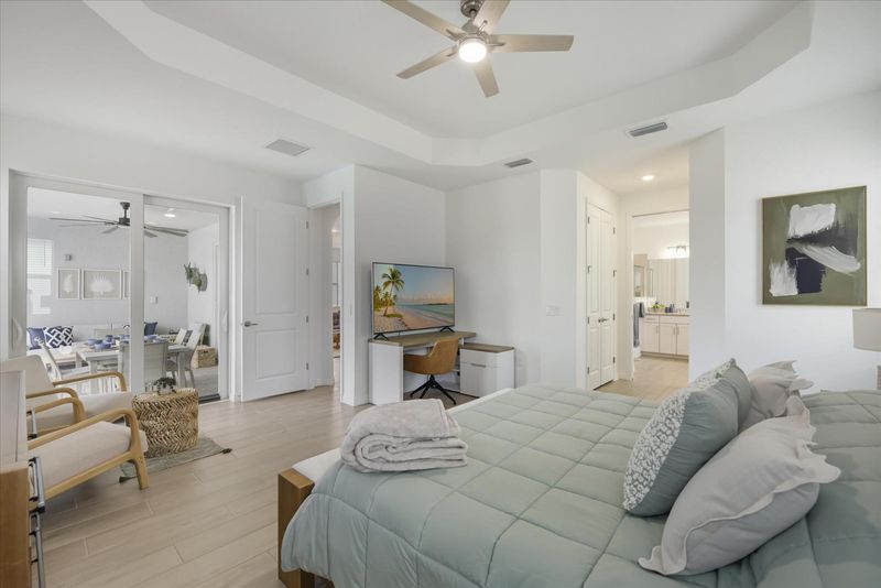 Primary bedroom with king bed, attached bathroom, lanai access, and 65-inch Smart TV