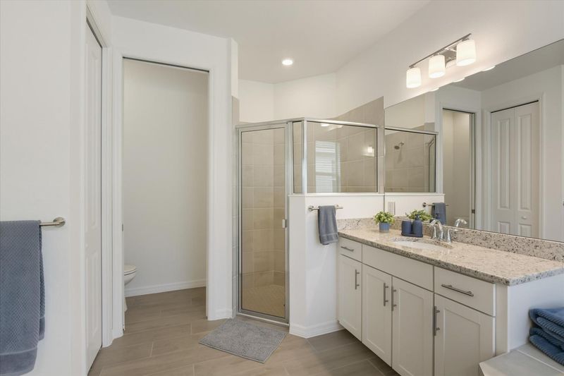 Primary attached bathroom with walk-in shower and garden tub