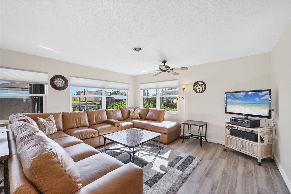 Bright, open living space. Livingroom features large sectional sofa and 50-inch Smart TV
