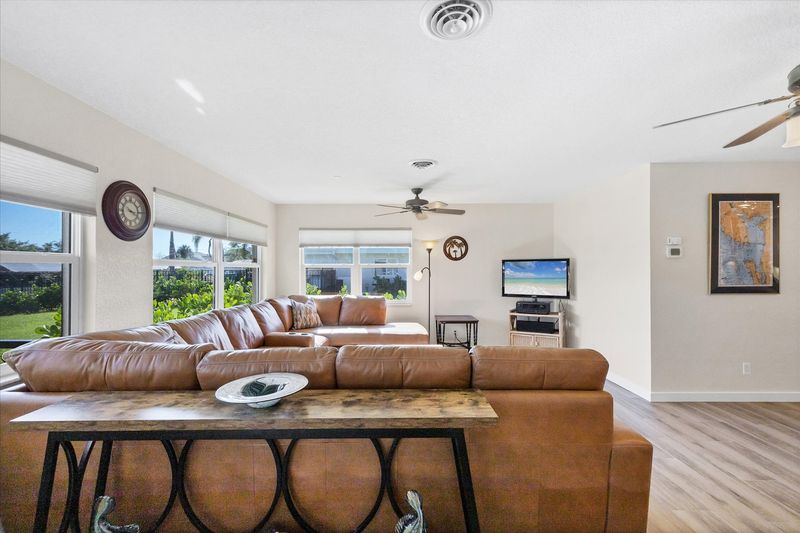 Bright, open living space. Livingroom features large sectional sofa and 50-inch Smart TV