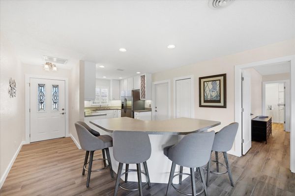 Fully-equipped kitchen overlooking the dining room and living room. Dining table seats 4 with an additional 4 at the kitchen island
