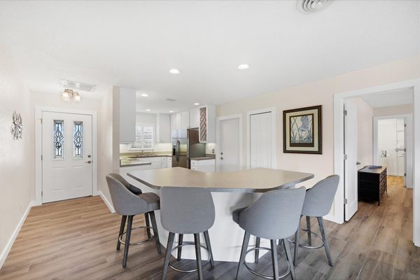 Fully-equipped kitchen overlooking the dining room and living room. Dining table seats 4 with an additional 4 at the kitchen island