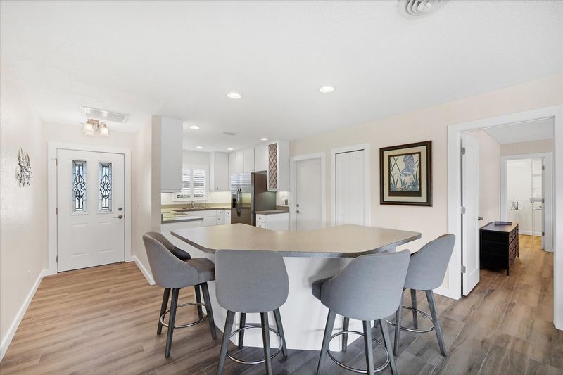 Fully-equipped kitchen overlooking the dining room and living room. Dining table seats 4 with an additional 4 at the kitchen island