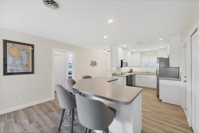 Fully-equipped kitchen overlooking the dining room and living room. Dining table seats 4 with an additional 4 at the kitchen island